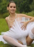 Tinytits ballerina posing in the grass