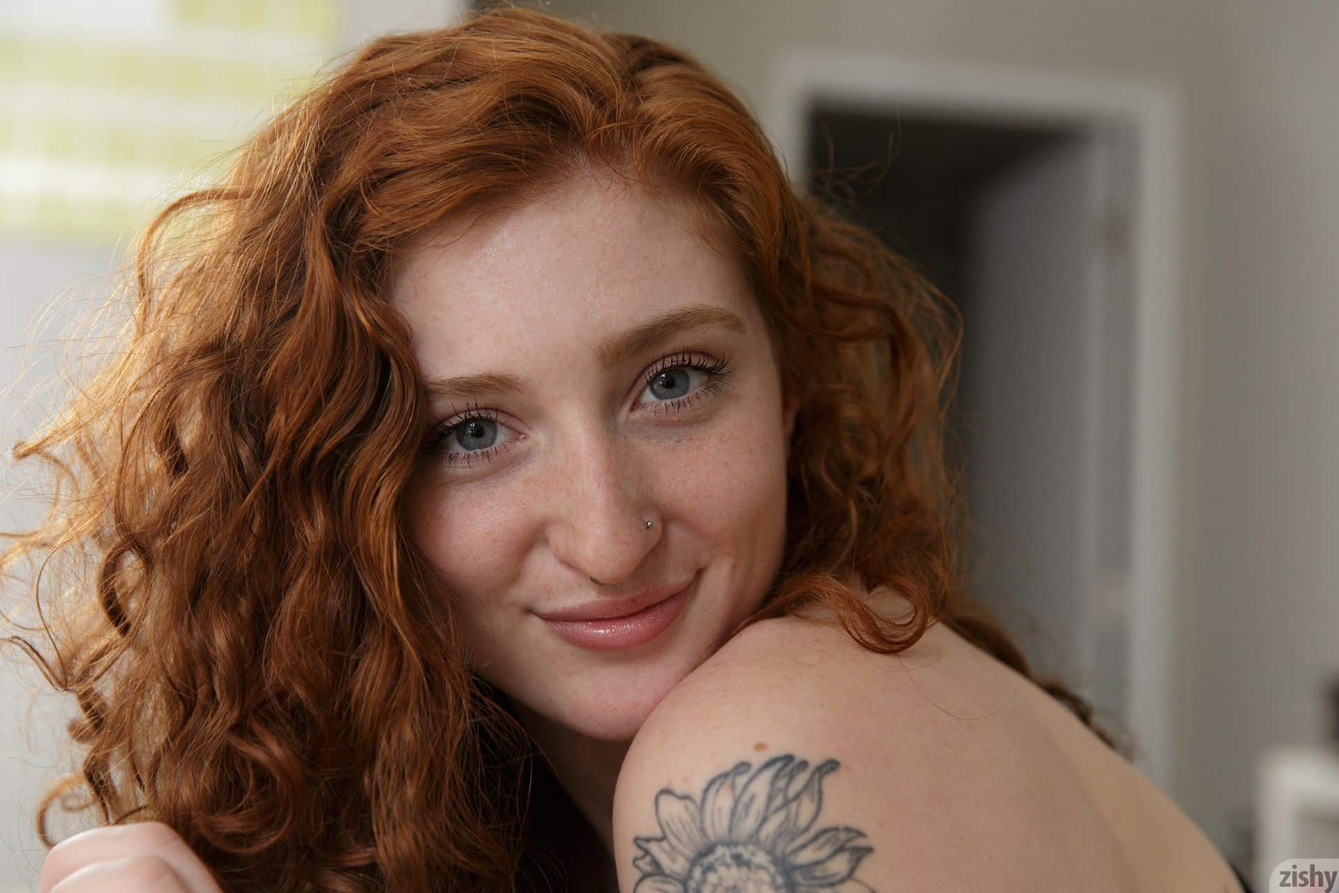 Closeup of freckled redhead Corsen Gilroy and her shoulder tattoo