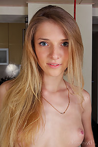 Freckled blonde teen stripping in the kitchen