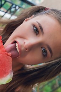 Cute busty teen with pigtails eating watermelon