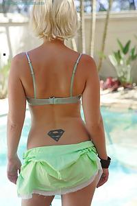 Blonde amateur shows off her tan lines by the pool