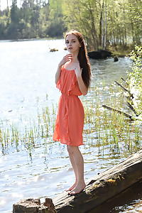 Skinny redhead teen nude by a lake