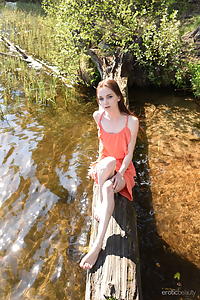 Skinny redhead teen nude by a lake