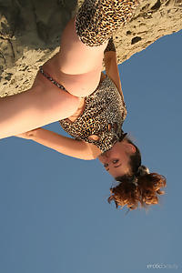 Redhead teen nude by a cliff