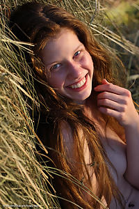Shaved redhead nude by a haystack
