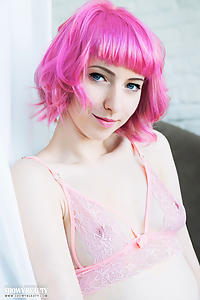 Pink-haired teen shows off her shaved pussy