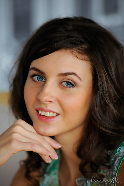 Shaved brunette with blue eyes posing