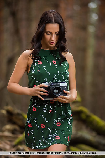 Sexy brunette lifts up her dress in a forest
