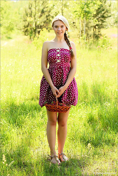 Shaved blonde teen lifts up her dress in a field
