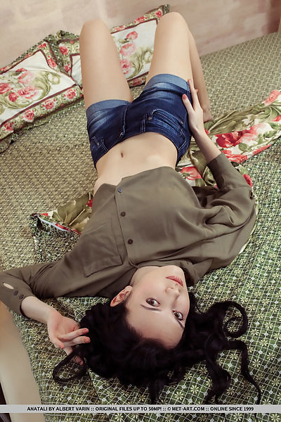 Black-haired model with big areolas spreads her legs