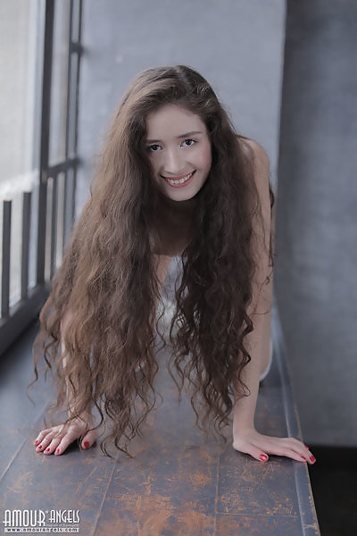 Long-haired brunette teen posing in long socks