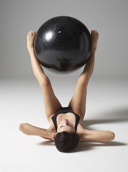 Short-haired babe posing on an exercise ball