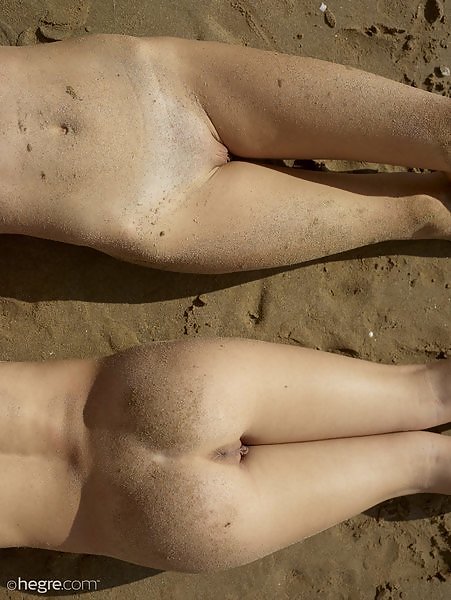 Flexible twins nude at the beach