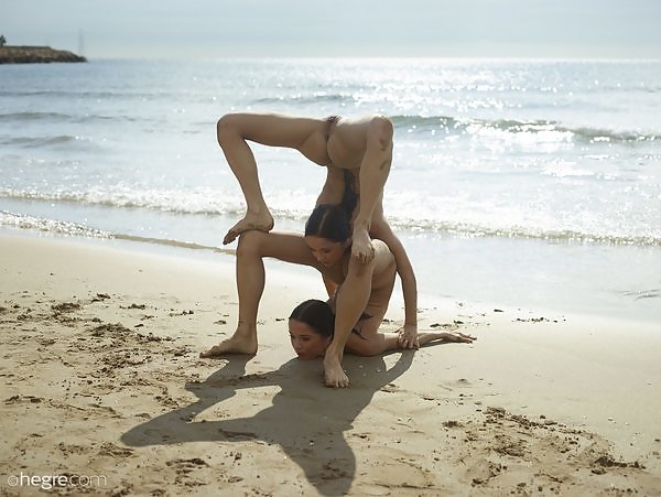 Flexible twins nude at the beach