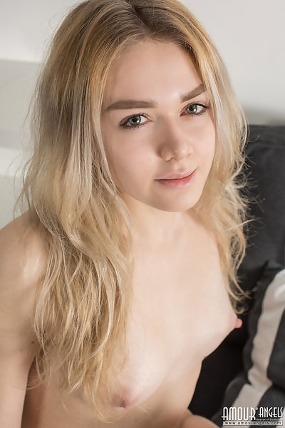 Cute blonde teen spreading on the couch