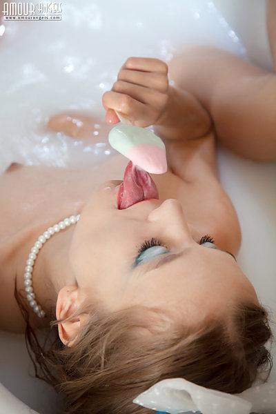 Shaved teen bathing in milk