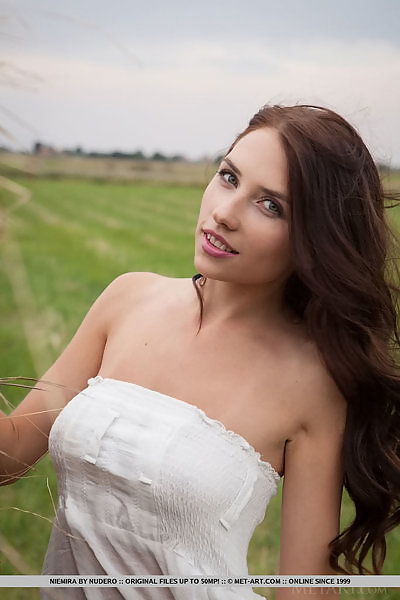 Busty brunette Niemira nude by a haystack