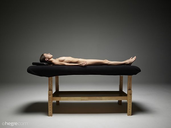Stunningly beautiful brunette teen nude on a massage table