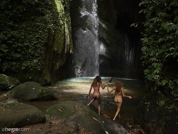Lesbian babes nude by a waterfall
