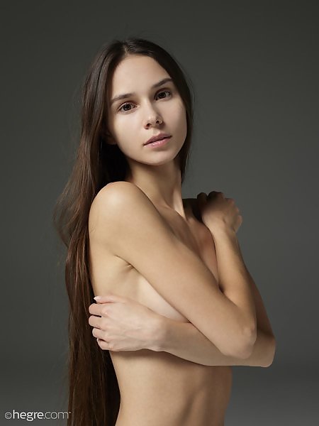 Stunning brunette teen with long hair nude in studio