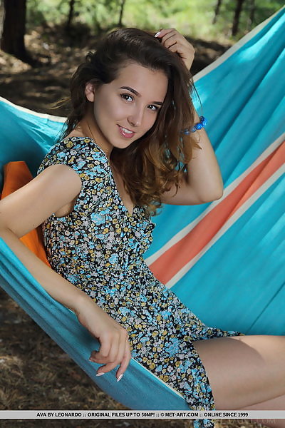Cute brunette teen spreading nude in a hammock