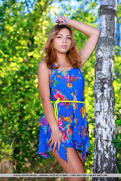 Shaved redhead teen takes off her dress in a forest