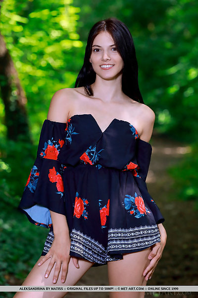 Black-haired teen spreading in a forest