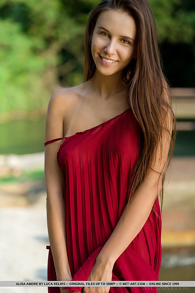 Gorgeous busty brunette takes off her dress outdoors