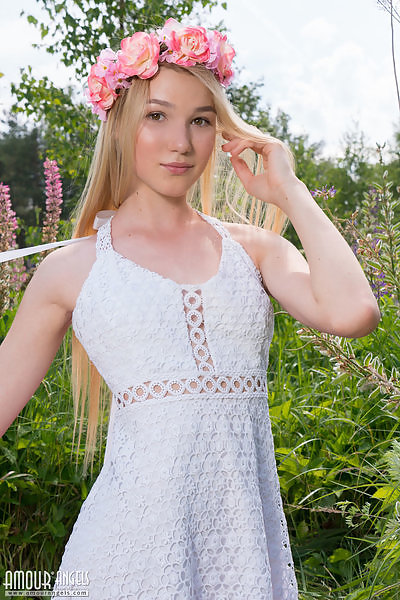 Adorable blonde teen nude in a field
