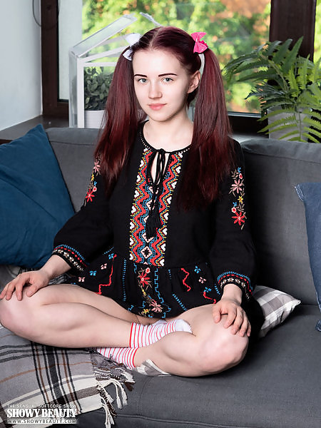 Busty red-haired teen spreading on the couch
