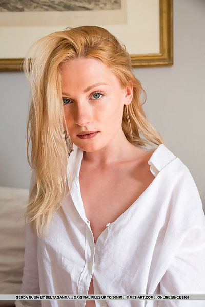 Sexy blonde with pale skin spreading in bed