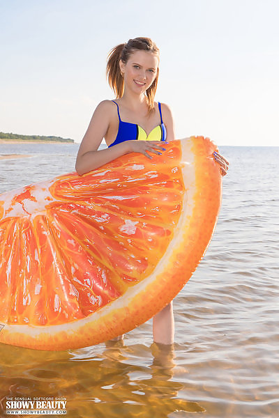 Cute redhead teen takes off her bikini at the beach