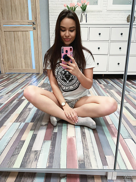 Sexy brunette taking selfies of her beautiful body