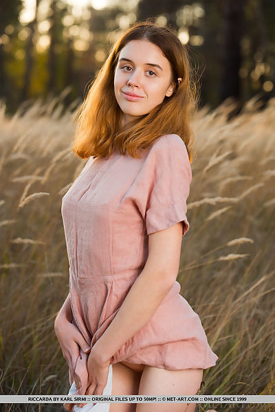 Shaved teen spreading in a field