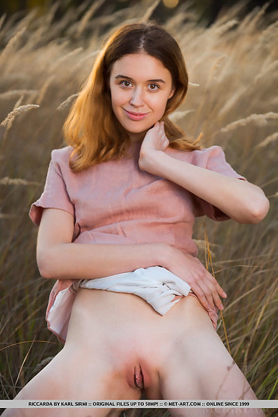 Shaved teen spreading in a field