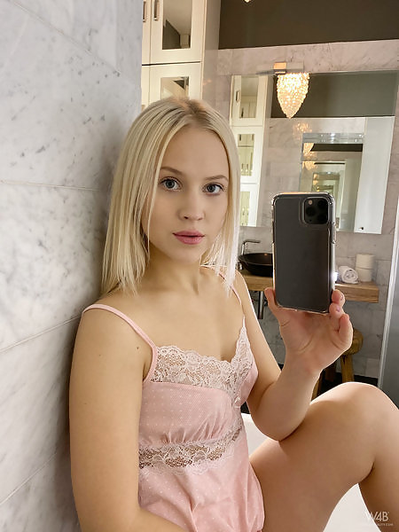 Cute blonde takes nude selfies