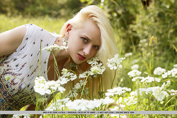 Shaved blonde with pale skin spreading in a forest