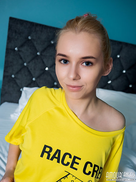 Cute blonde teen with blue eyes shows off her bald pussy