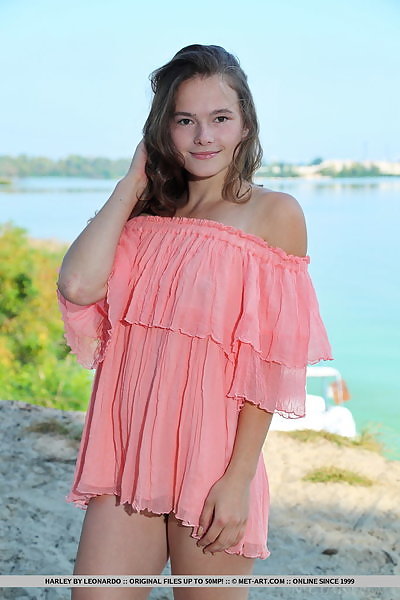 Flat-chested teen spreads her holes by the shore