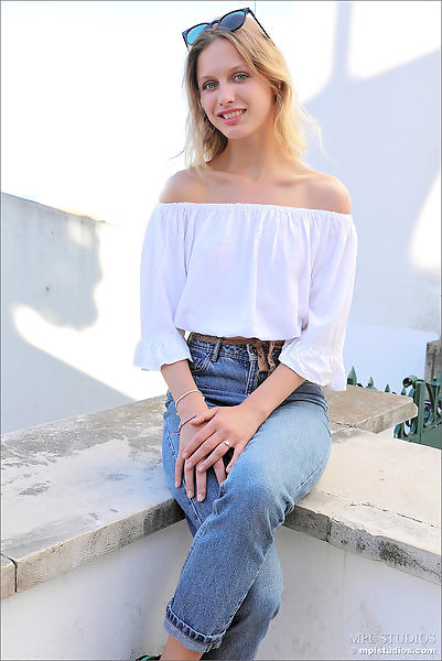 Flat-chested blonde posing around town