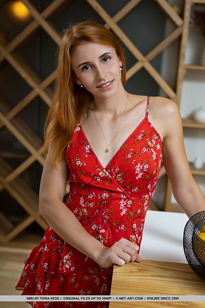 Athletic redhead takes off her red dress