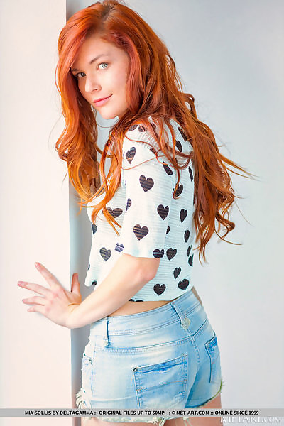 Freckled redhead takes off her jean shorts