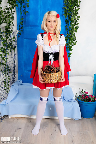 Blonde teen dressed as the little red riding hood
