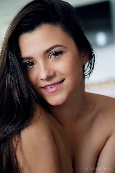 Black-haired teen posing nude