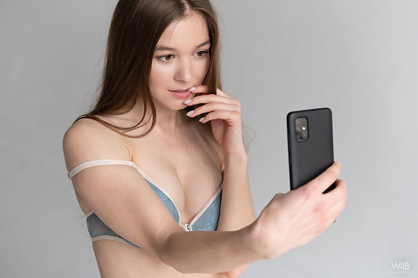 Sexy brunette teen taking selfies