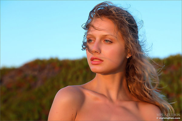 Flat-chested girl nude at sunset