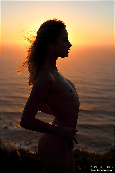 Flat-chested girl nude at sunset