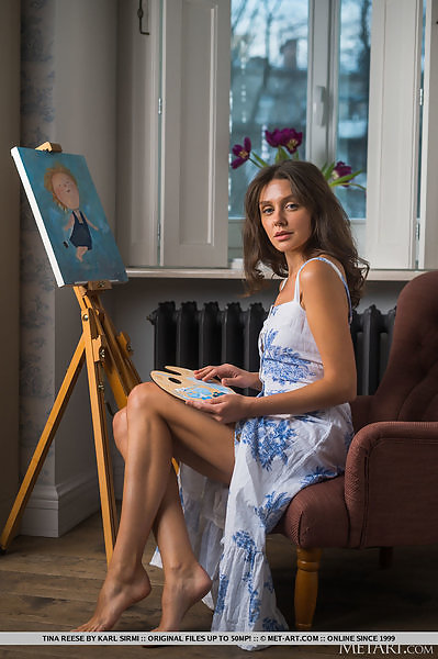Blue-eyed artist spreading on a chair