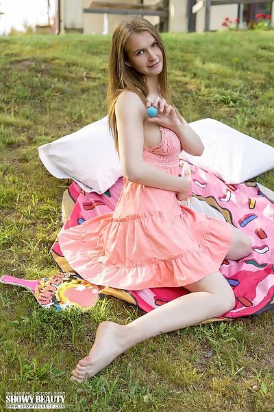 Shaved blonde teen lifts up her dress in the backyard
