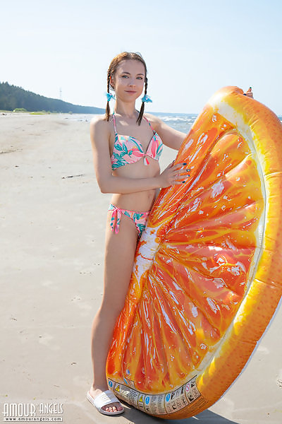 Cute teen takes off her bikini at the beach
